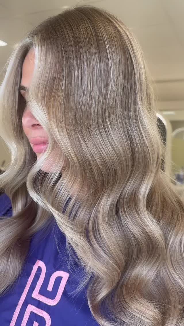 Long ash-blonde waves with bright, light face-framing highlights