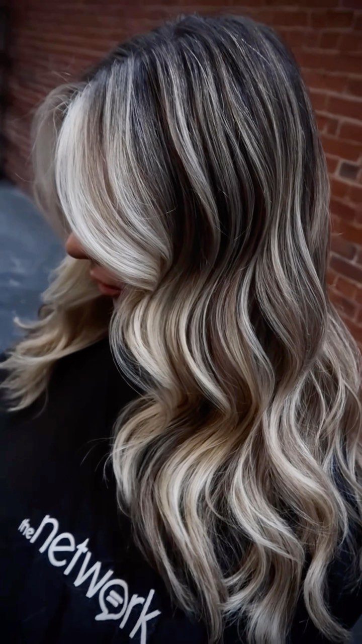 Wavy dark ash hair with silver blonde highlights and lighter ends