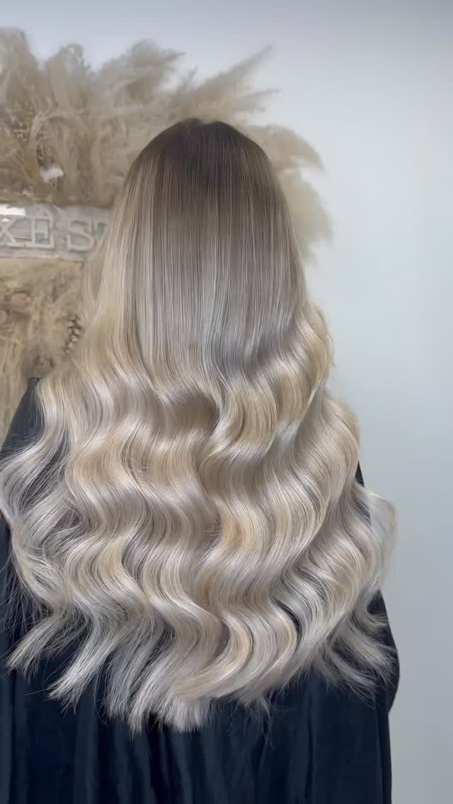 Long wavy gray hair with bright frosted white highlights at the ends
