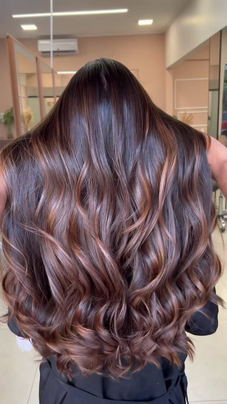 Long dark hair with bronze taupe ribbons styled in glossy loose curls