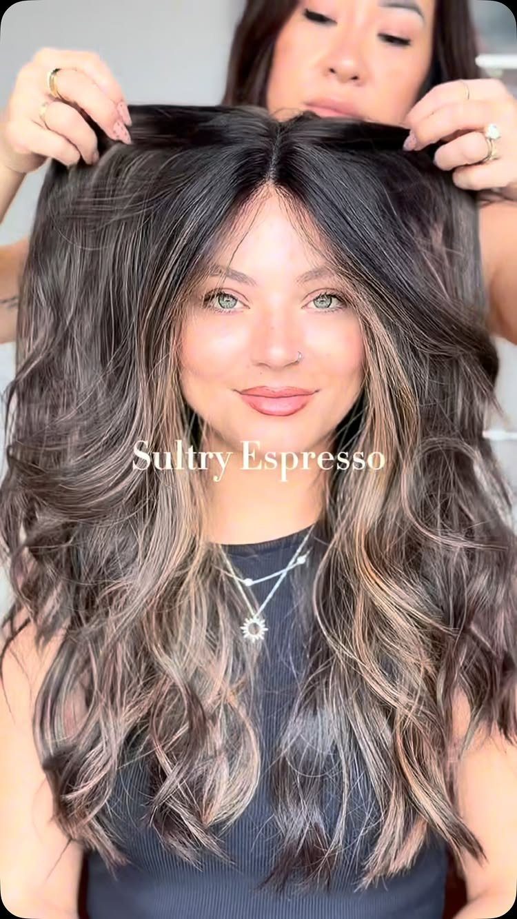Long espresso-brown waves with fine pale highlights shown in a salon