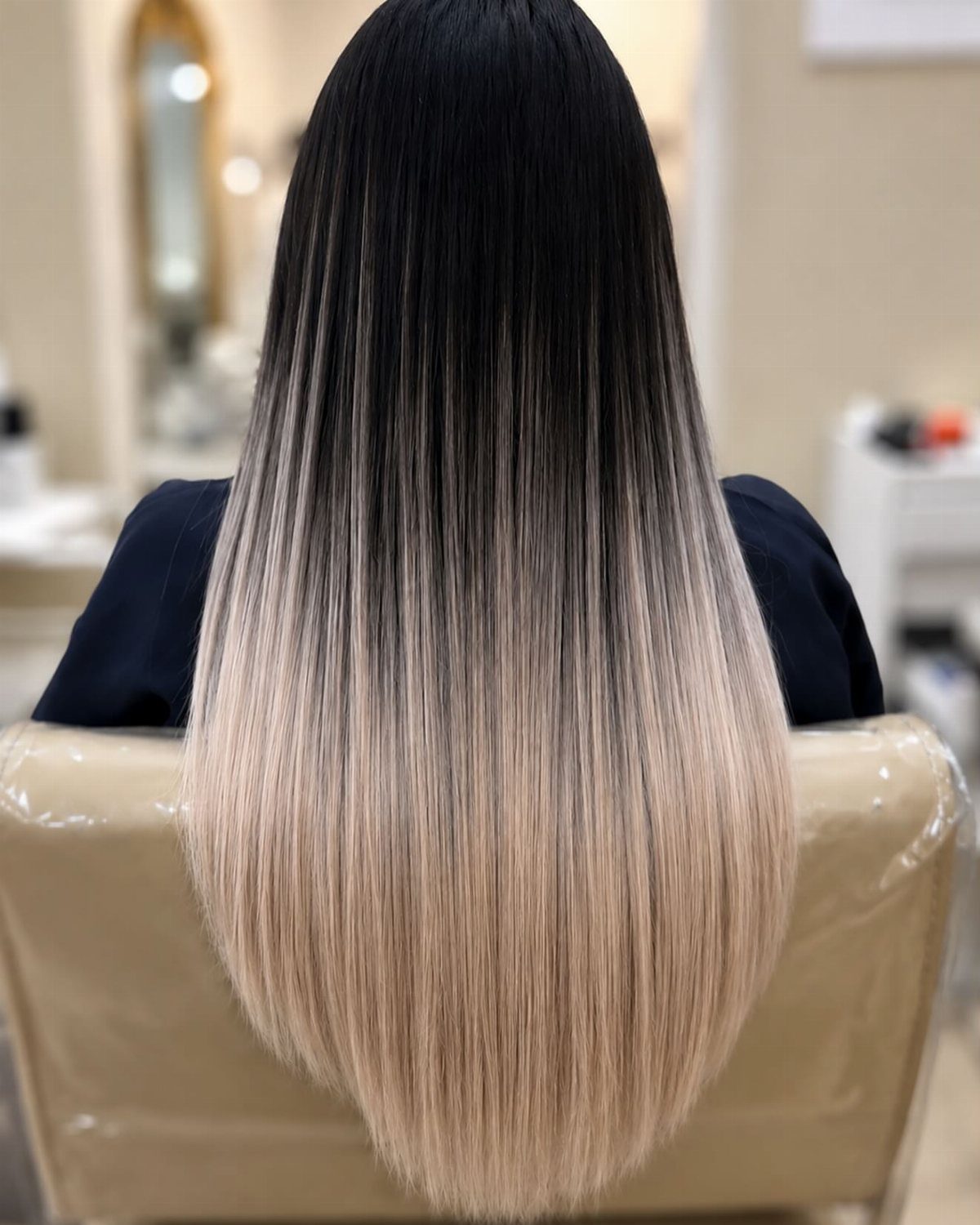 Long straight black hair fades into pale blonde, lightened ends