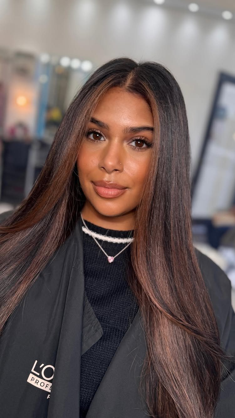 Woman with long dark hair and blended brown tones through the lengths