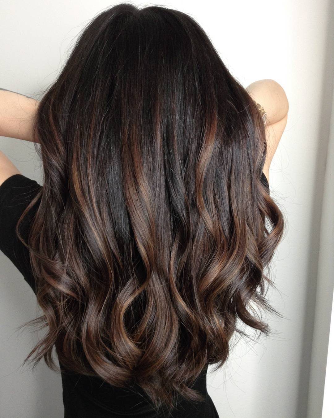 Wavy dark hair with soft espresso brown balayage through the lower lengths