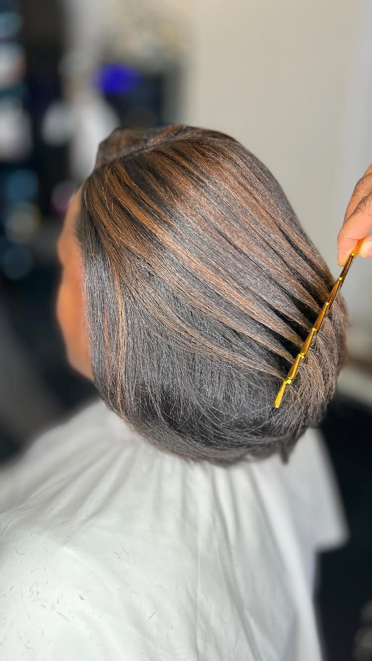 Dark brown hair with fine chocolate-brown highlights in a salon