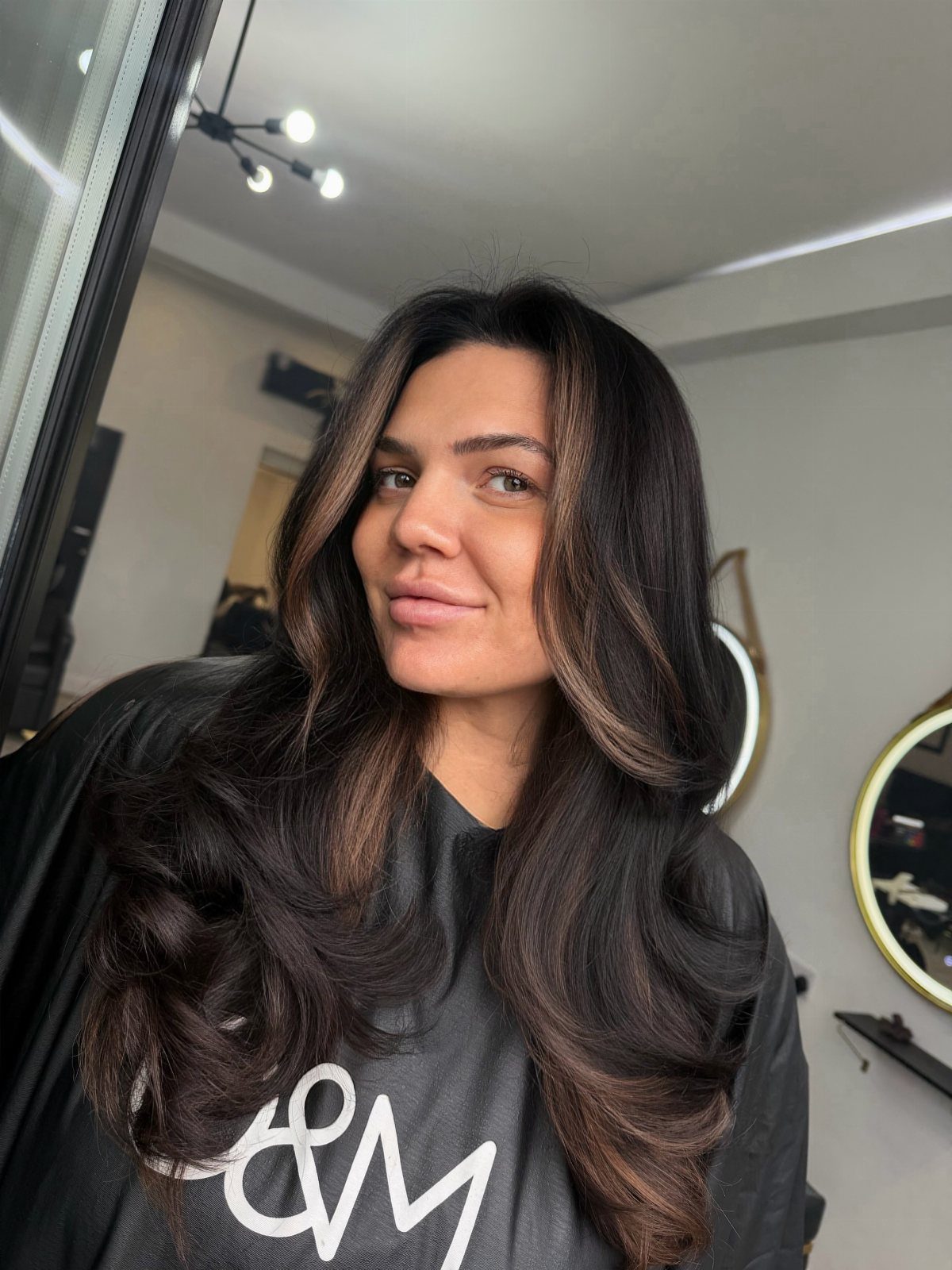 Woman with long dark chocolate hair fading into warm bronze-brown ends