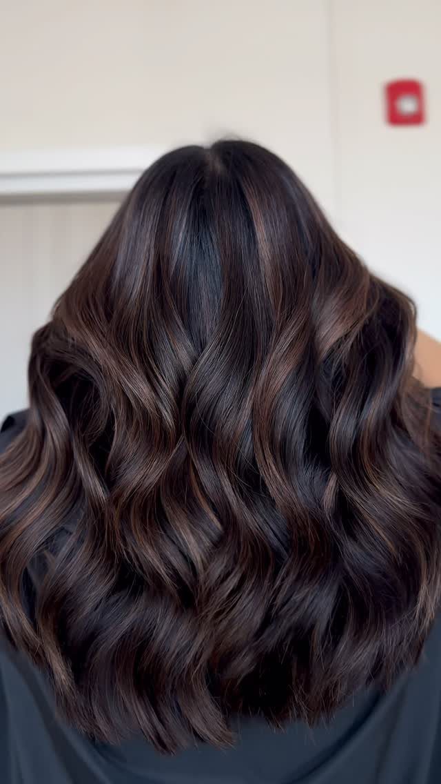 Wavy dark brown hair with subtle mocha and milky-brown highlights