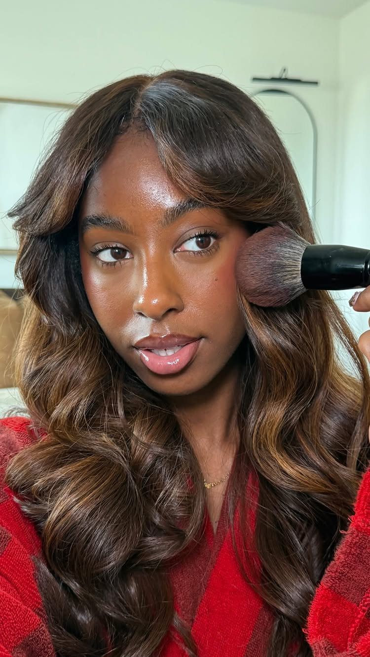 Woman with espresso roots and caramel brown highlights in long waves