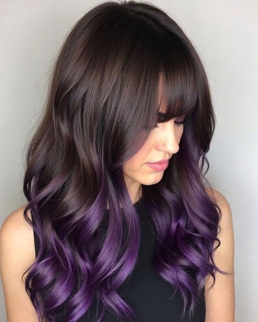 Long dark layered hair with bangs and vivid purple streaks curling through the ends