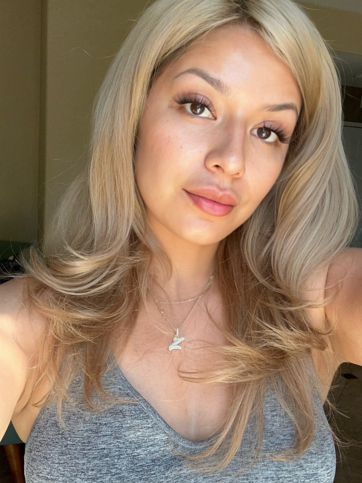 Woman with long bright blonde hair and soft honey-toned strands framing her face