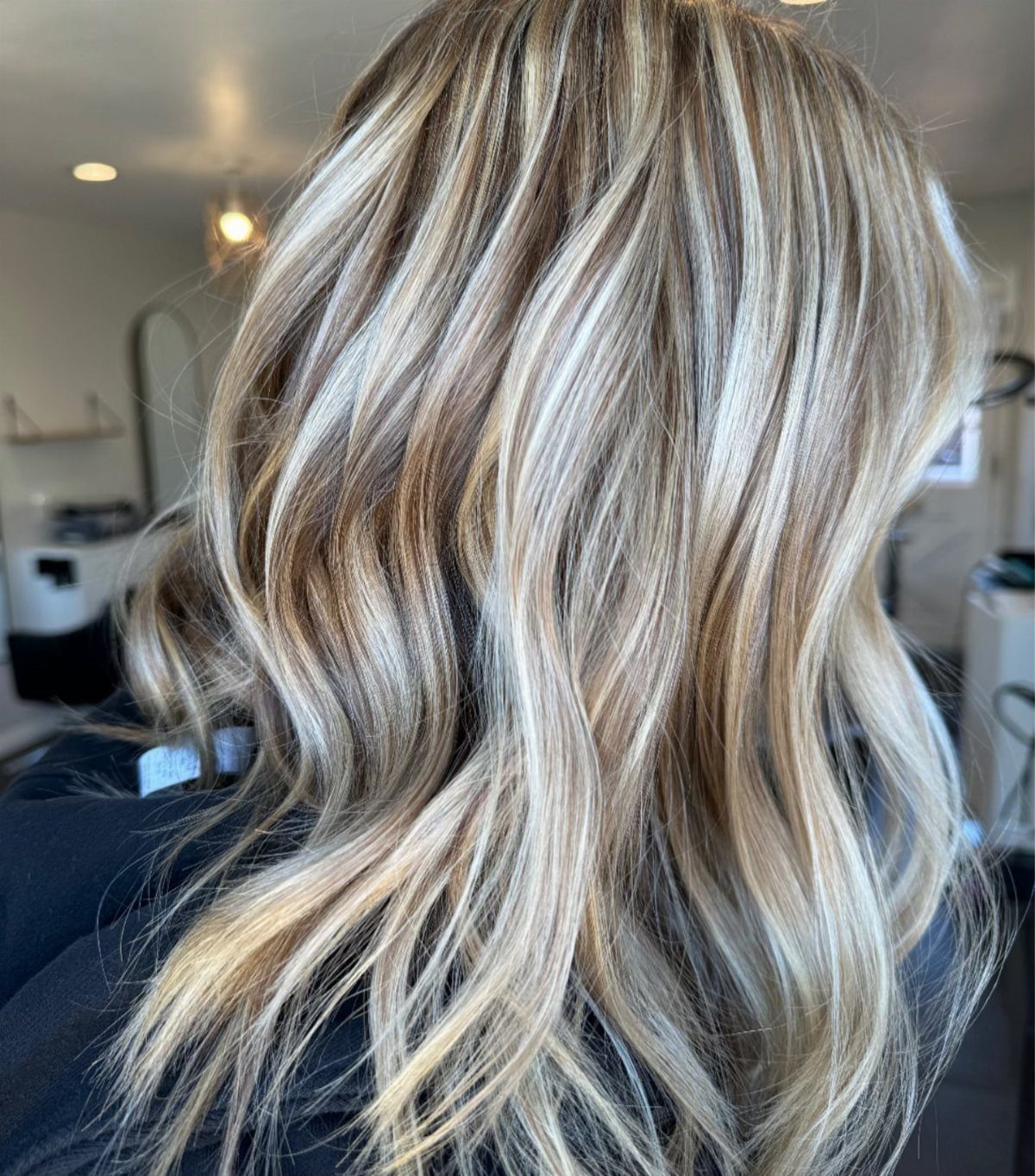 Long wavy dirty-blonde hair with dimensional beige highlights and subtle lowlights