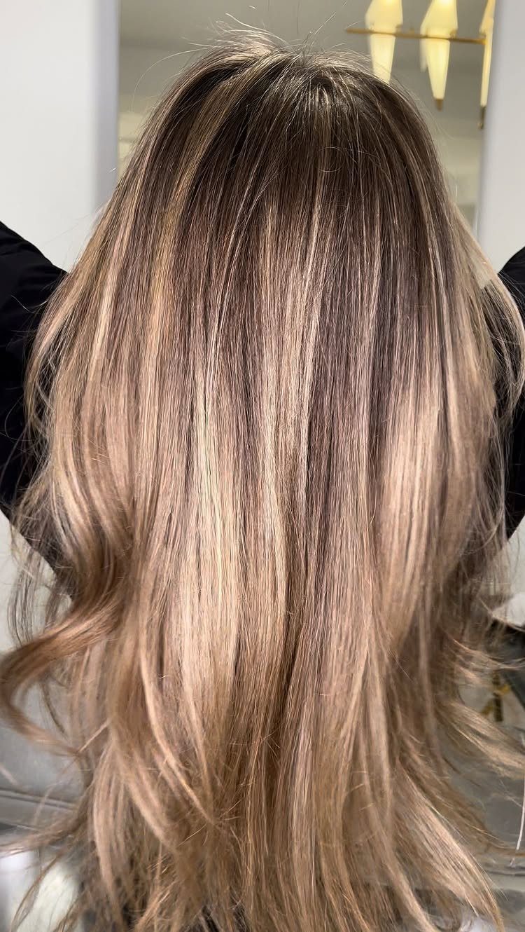 Long brunette hair with soft honey-blonde ribbons and flowing waves