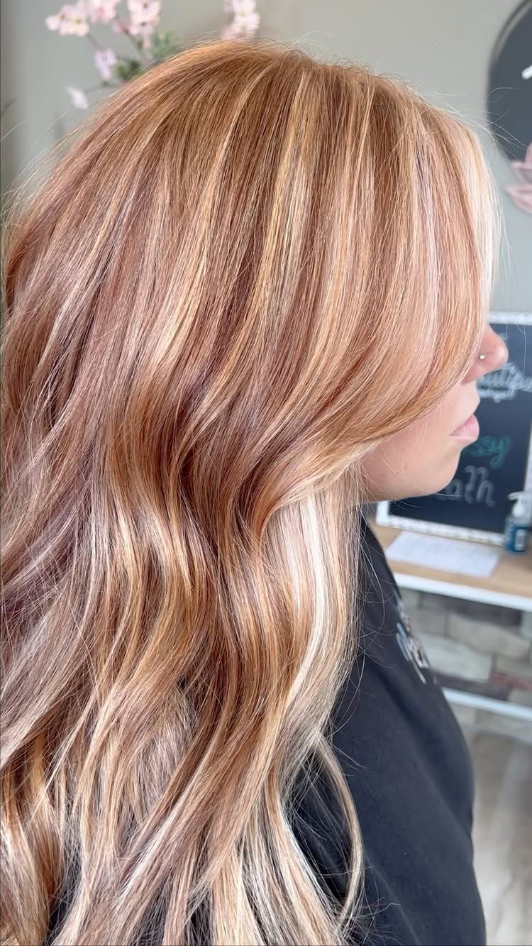 Long wavy copper strawberry blonde balayage with lighter blonde ribbons