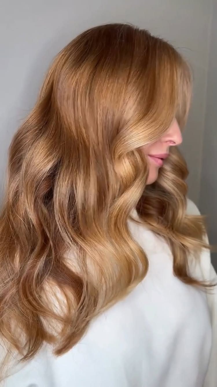 Long wavy golden honey hair with warm strawberry blonde tones