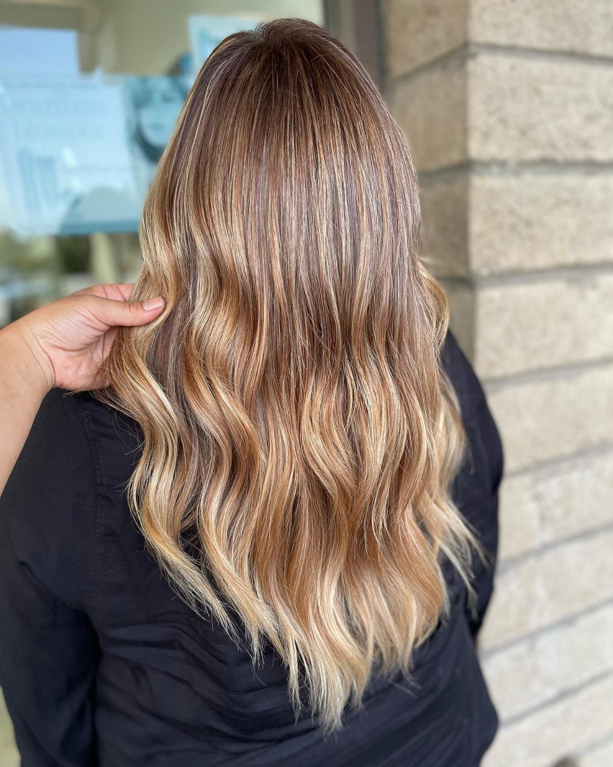Long wavy hair with strawberry blonde balayage and pale highlighted ends