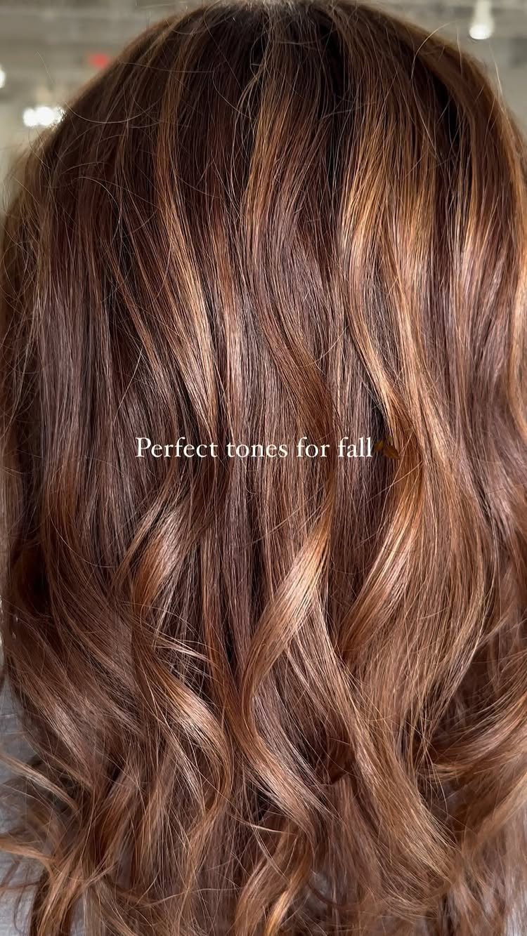 Long auburn-brown waves with copper and blonde highlights and lighter streaks