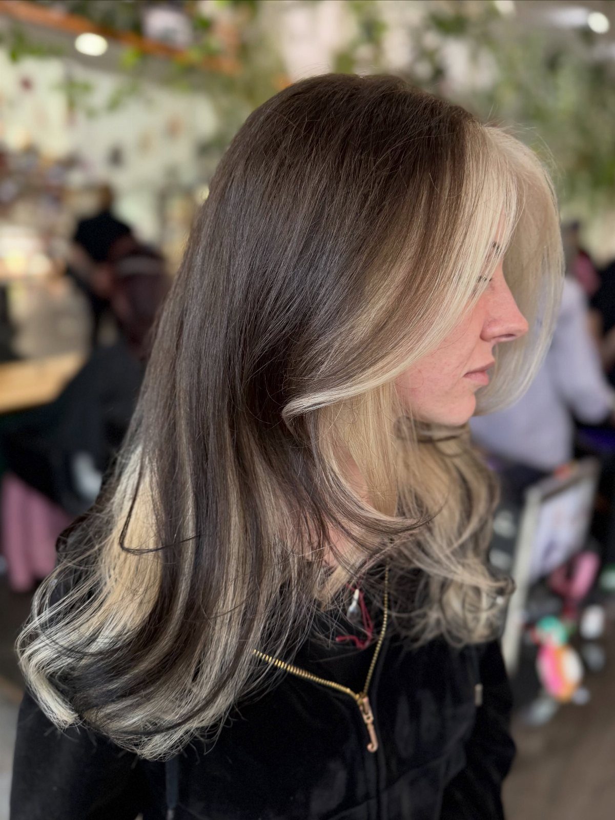 Long brunette hair with chunky blonde face-framing highlights and lighter ends
