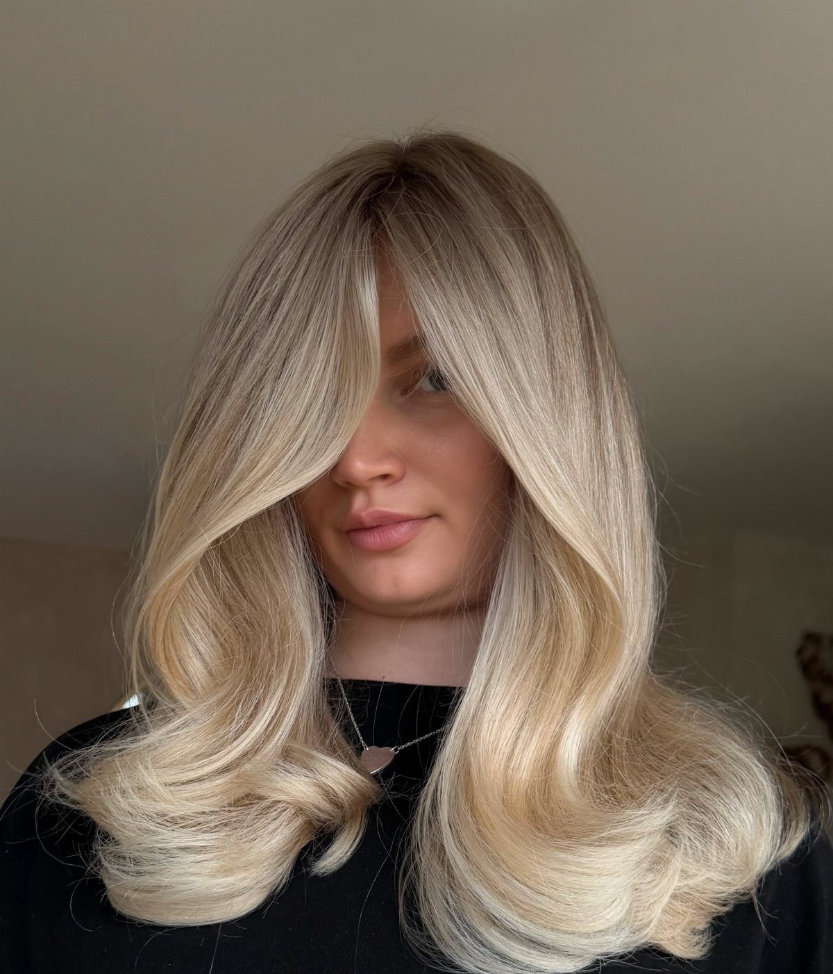 Woman with dimensional blonde hair, bright face-framing highlights and darker lowlights