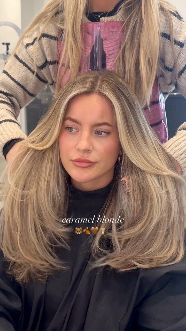 Woman with long blonde hair showing blended caramel highlights and darker brown lowlights