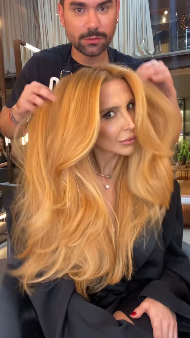 Woman with long golden strawberry-blonde hair seated in a salon