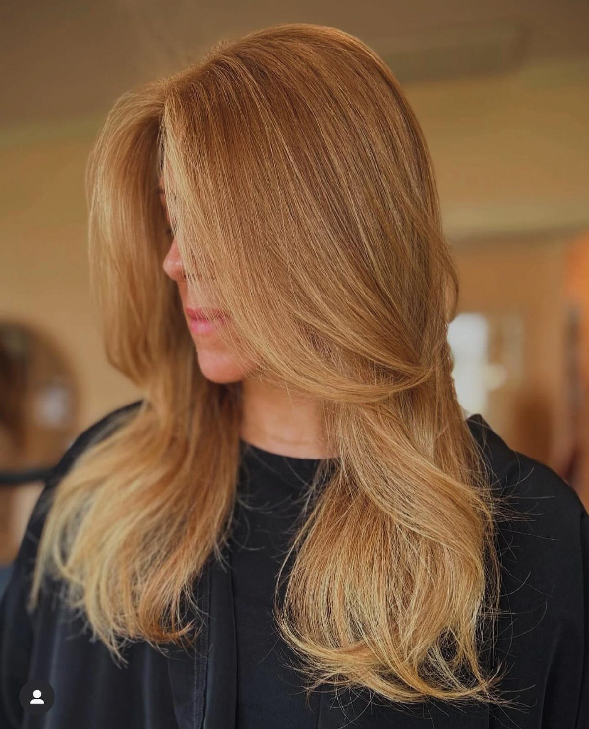 Woman with long strawberry blonde hair and sunny golden highlights