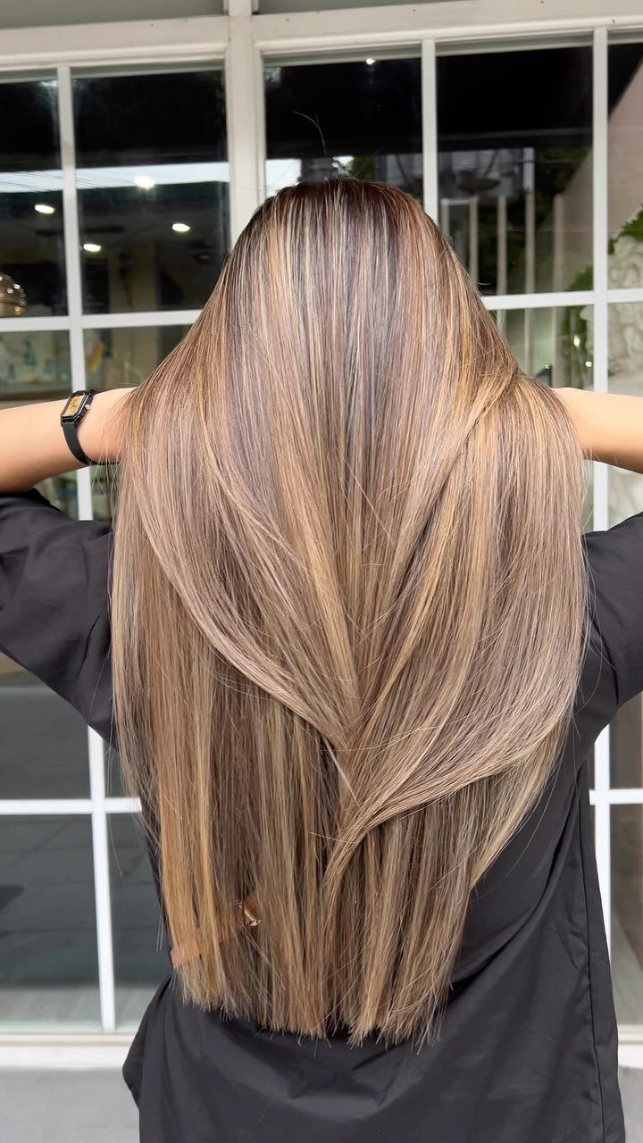 Long brunette hair with blended caramel balayage highlights viewed from the back