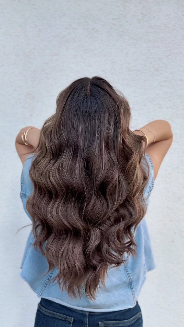 Long wavy mushroom brown balayage hair viewed from behind