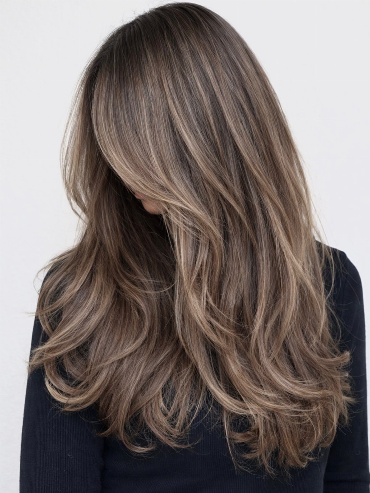 Long layered brunette hair with cool taupe and beige highlights