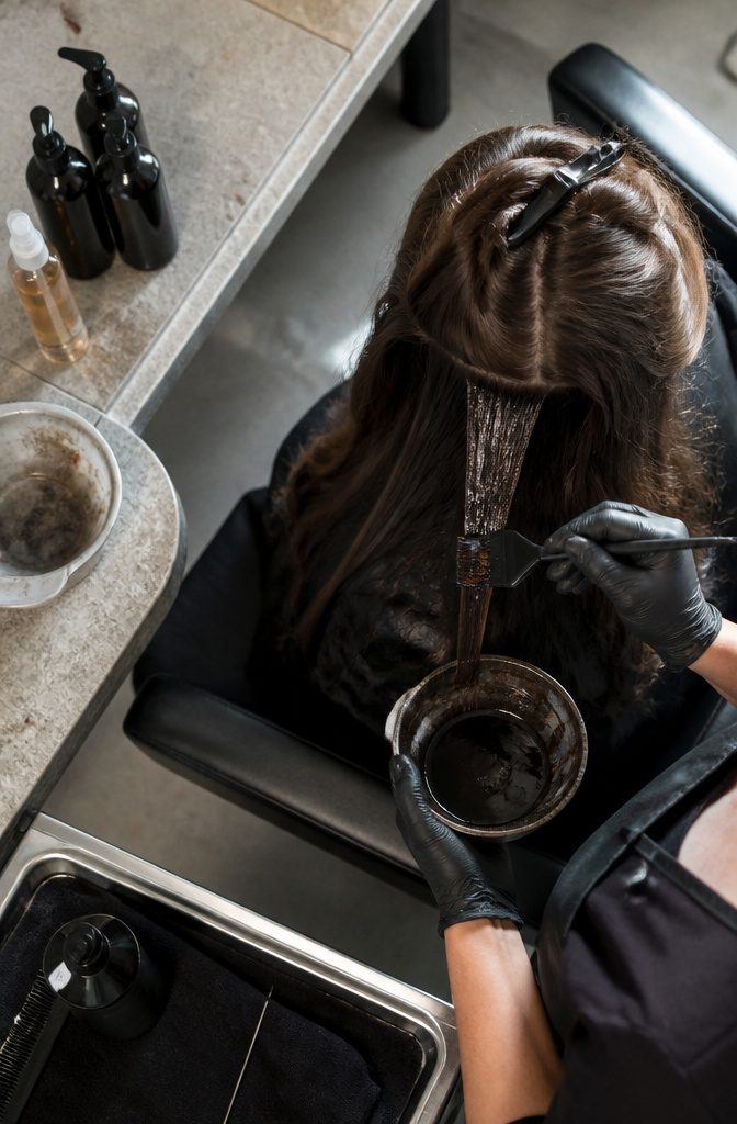 Hair gloss products beside shiny brown hair