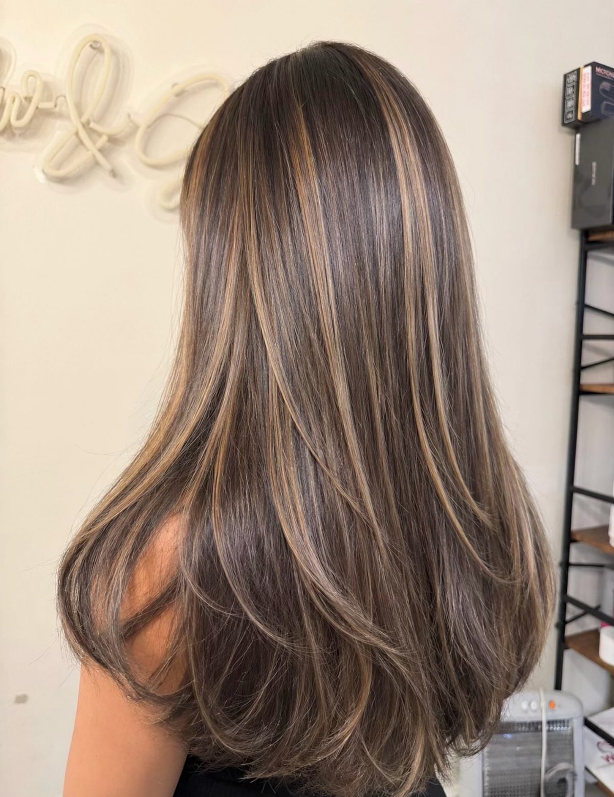 Dark brown hair with fine, high-contrast caramel-blonde balayage highlights
