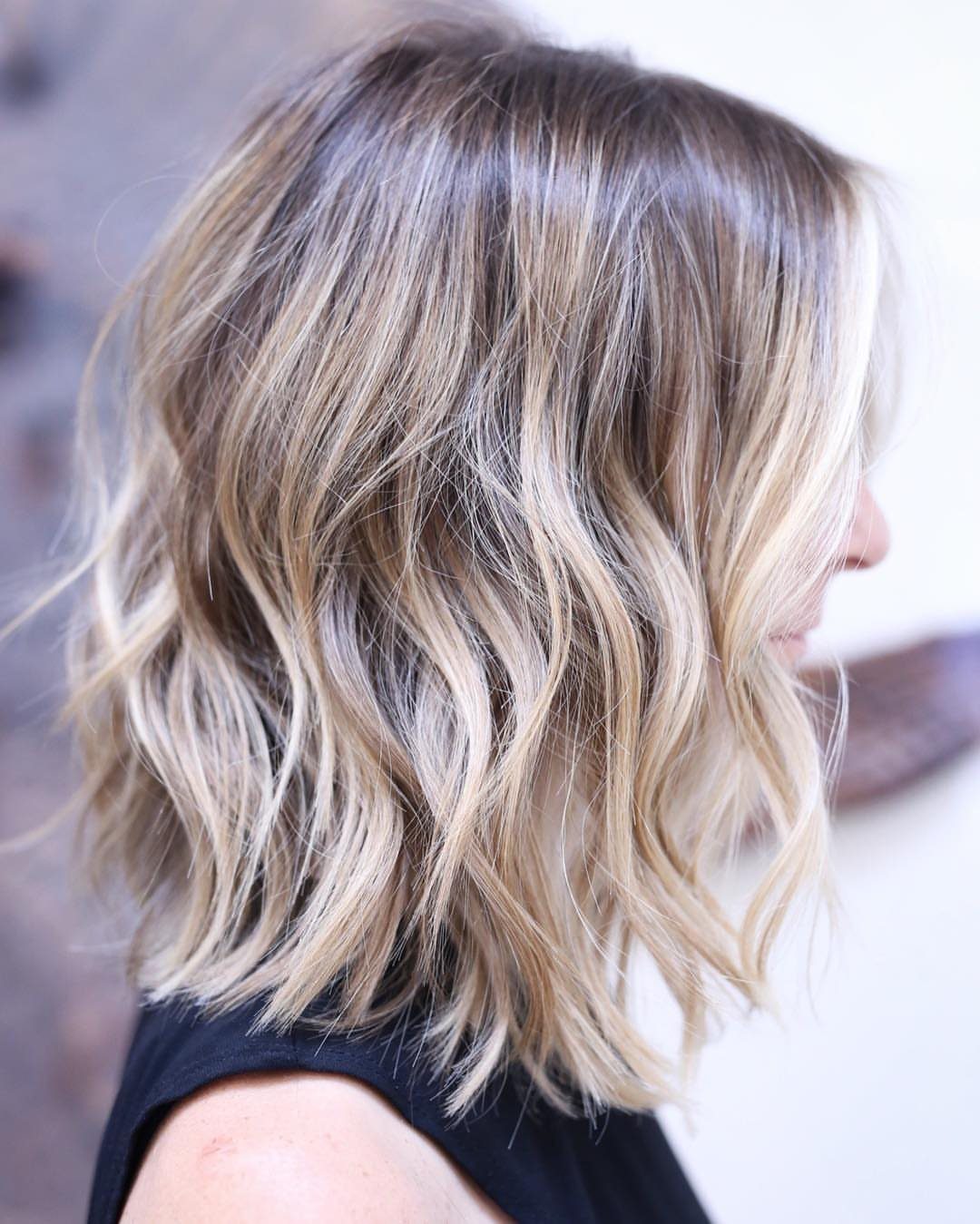 Shoulder-length wavy brown hair with chunky pale blonde highlights