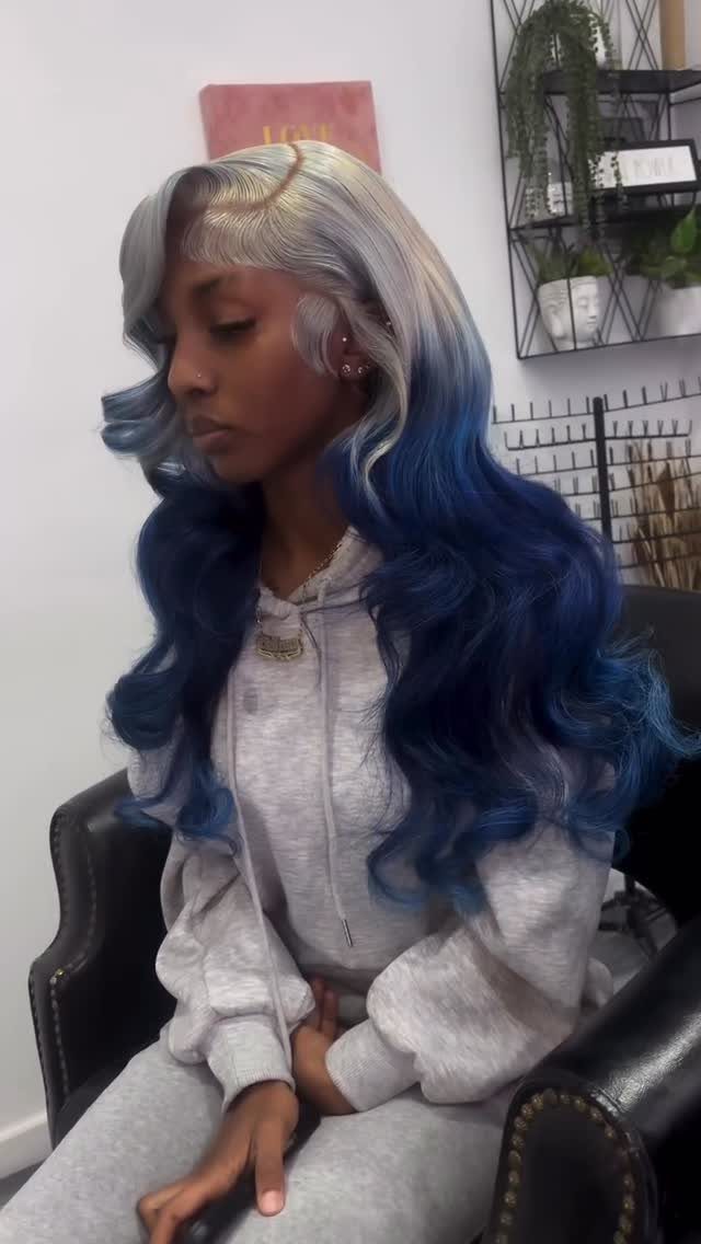 Woman showing long silver-blonde hair fading into deep blue curls