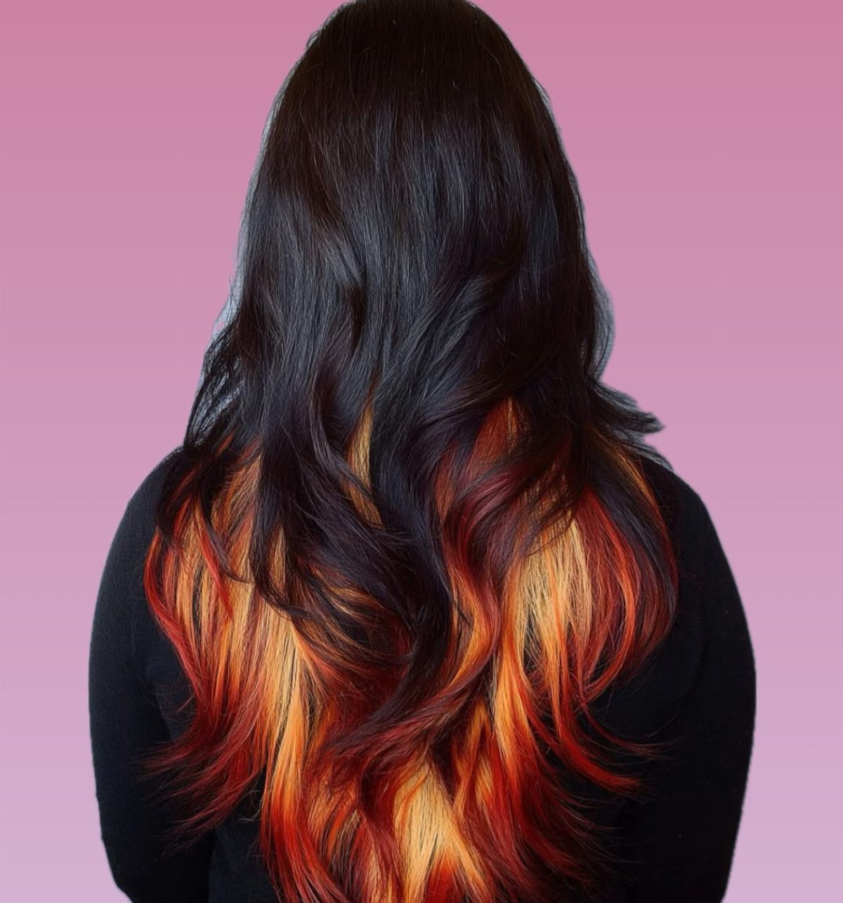Long dark waves transition into fiery red, orange, and yellow ends