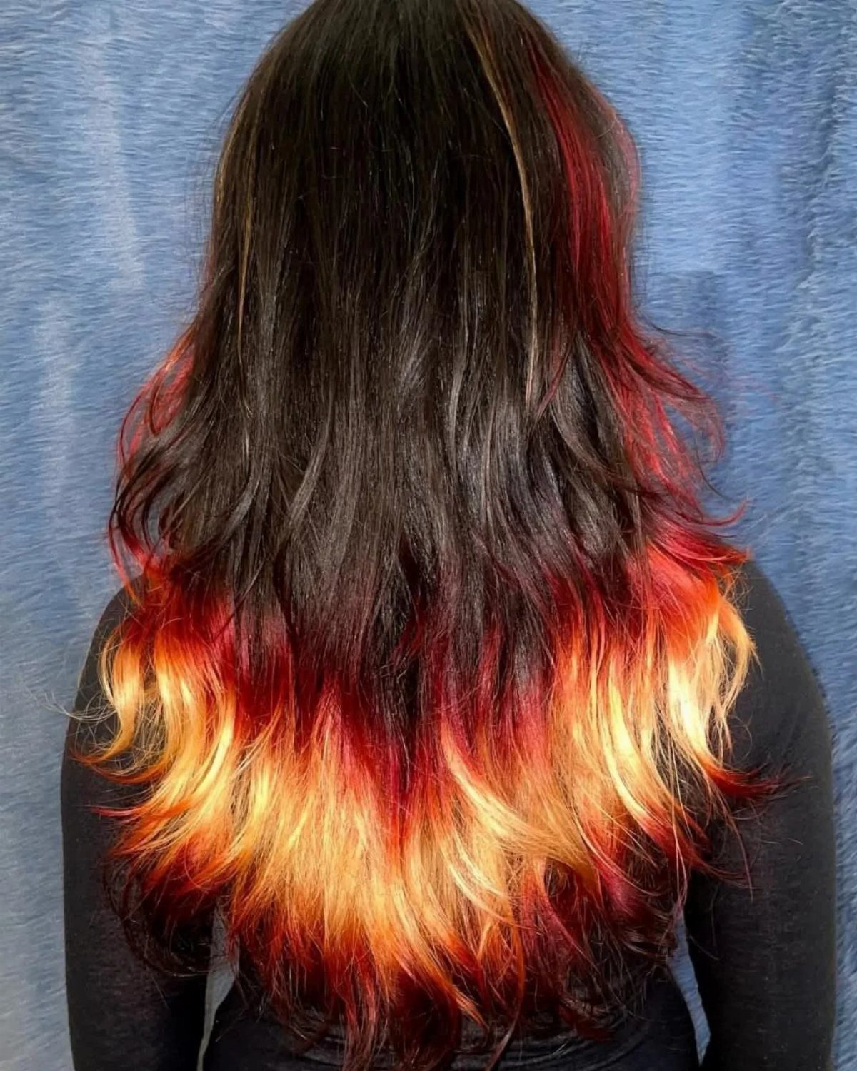 Long dark hair with fiery red, orange, and golden ombre ends