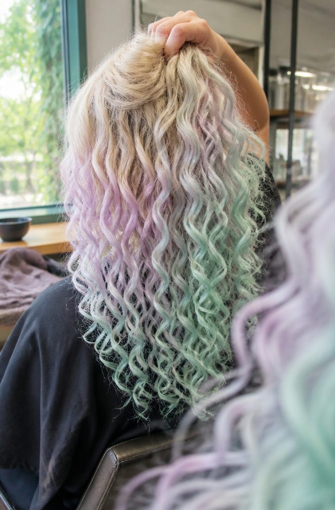 Light blonde curls colored in pastel lilac and mint tones