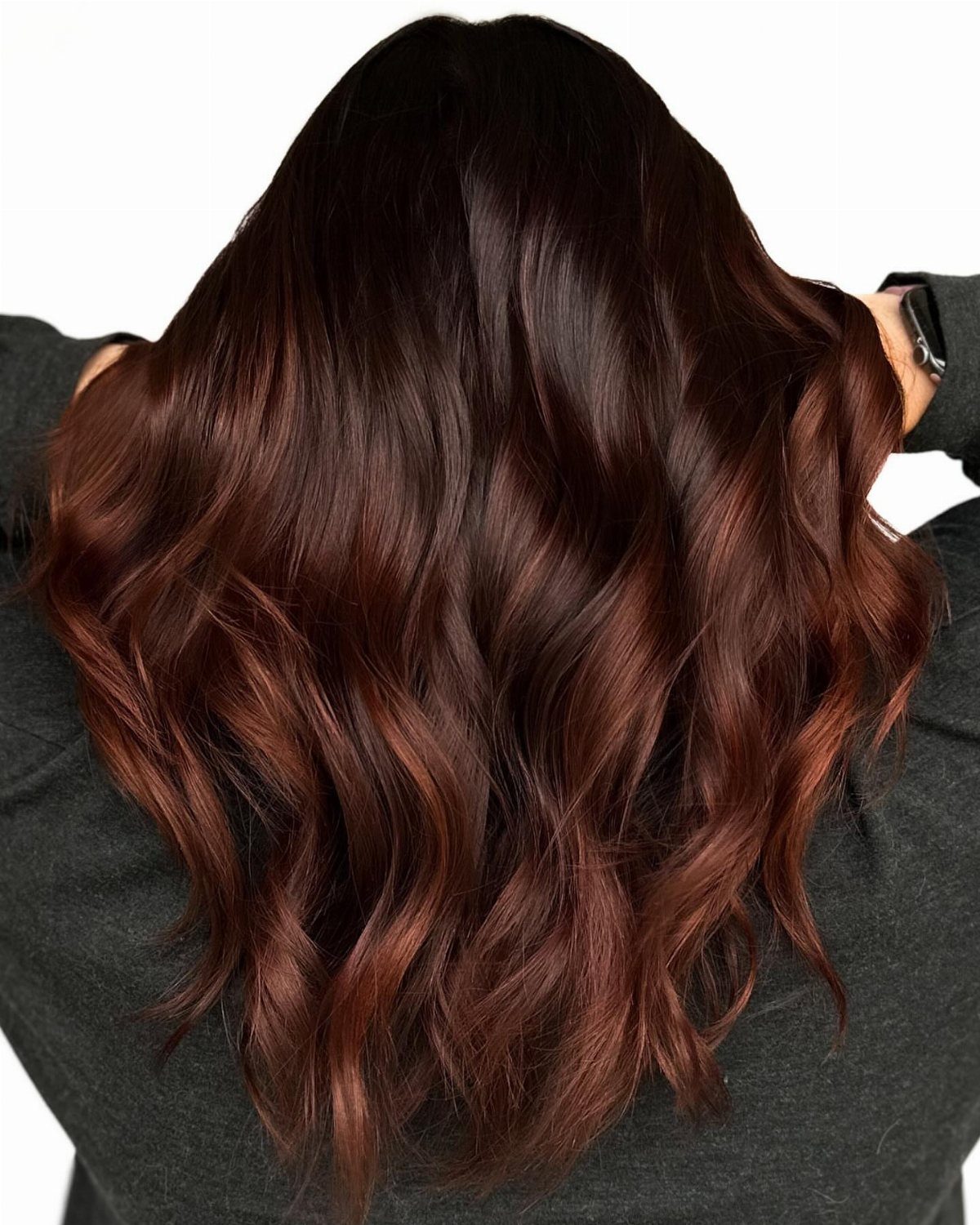 Long dark brunette waves with warm auburn and reddish-brown highlights