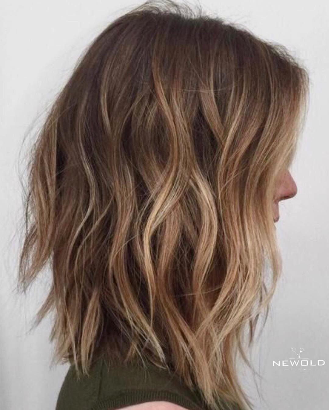 Shoulder-length brown hair with blended lighter bronze-brown highlights