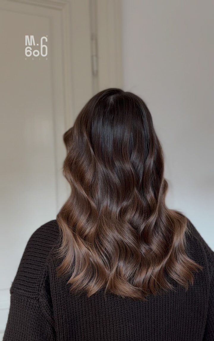 Long wavy dark brown hair fading into lighter chocolate brown ends
