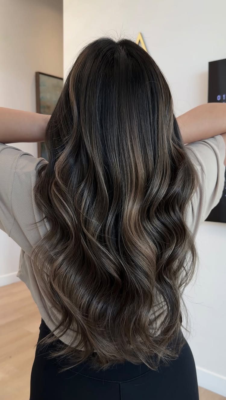 Long dark brunette waves show muted, cool ash brown highlights