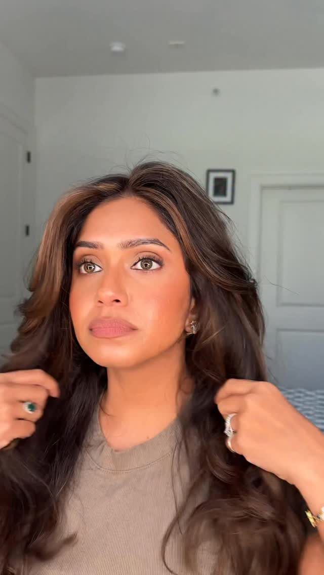 Woman showing long dark brunette hair with subtle caramel babylights and soft waves