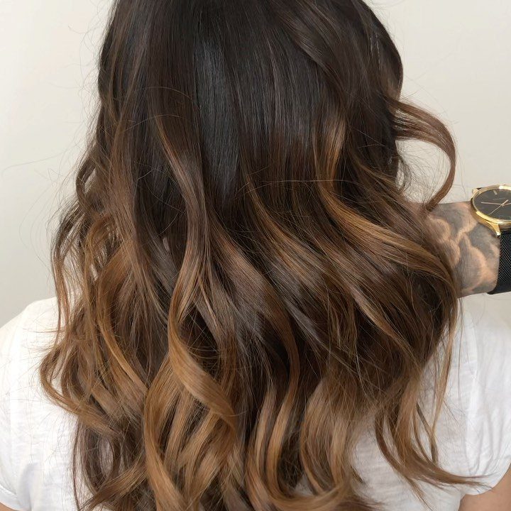 Wavy dark brunette hair blending into lighter chocolate-brown lengths and ends