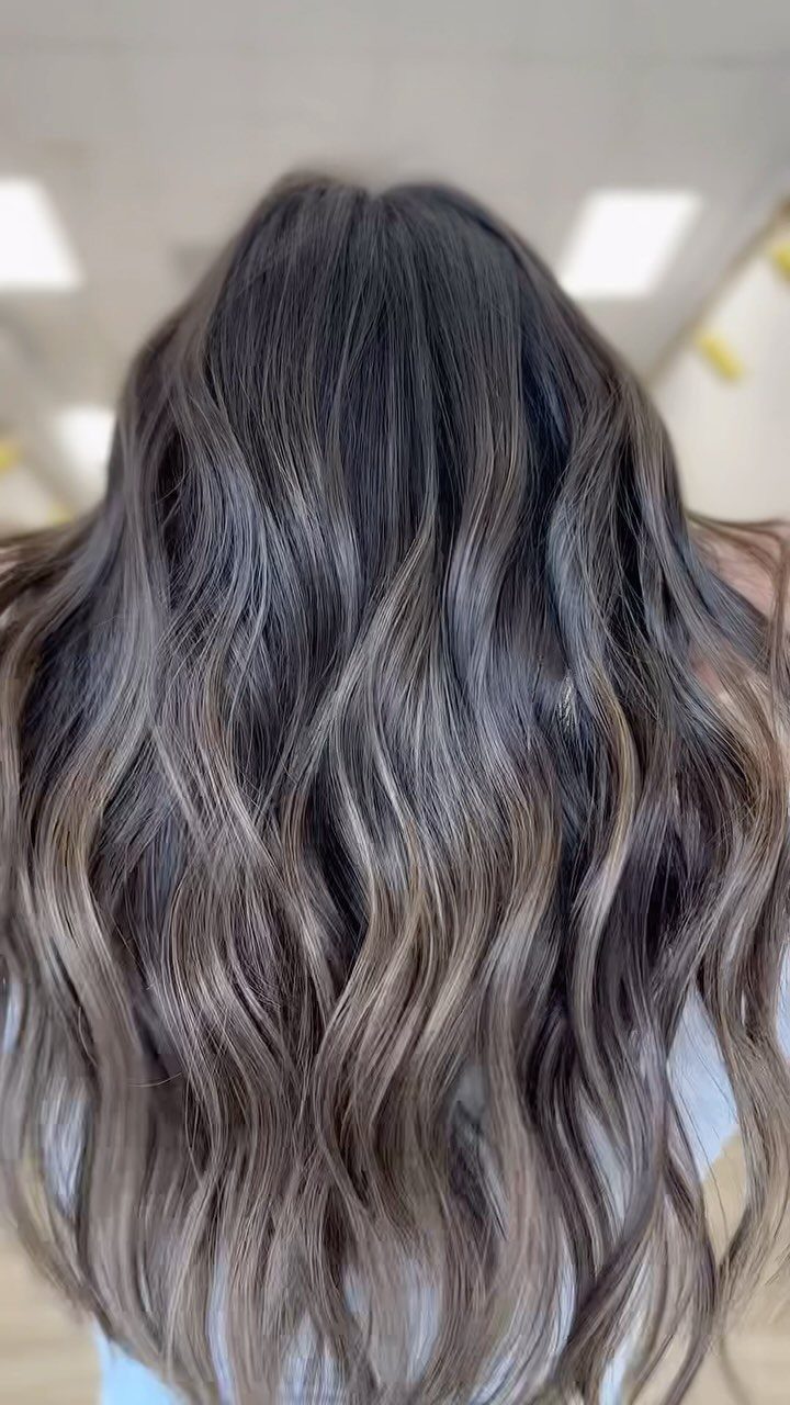 Long dark wavy hair with cool ash-brown highlights throughout