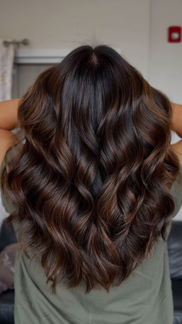 Long espresso-brown waves show subtle soft brown highlights throughout