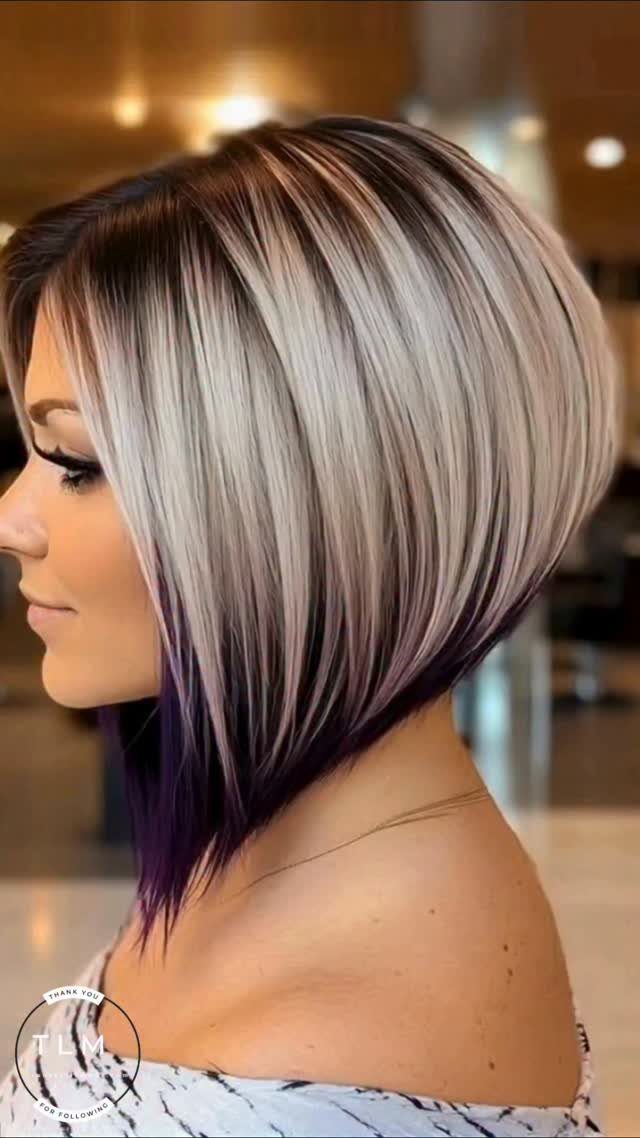 Short angled bob with dark roots and prominent silver-gray partial highlights