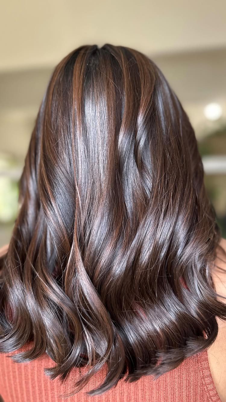 Long dark brown waves with subtle mocha-toned highlight ribbons
