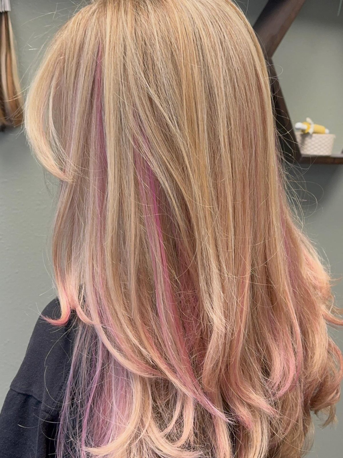 Long dirty-blonde hair with pink highlights and loose waves