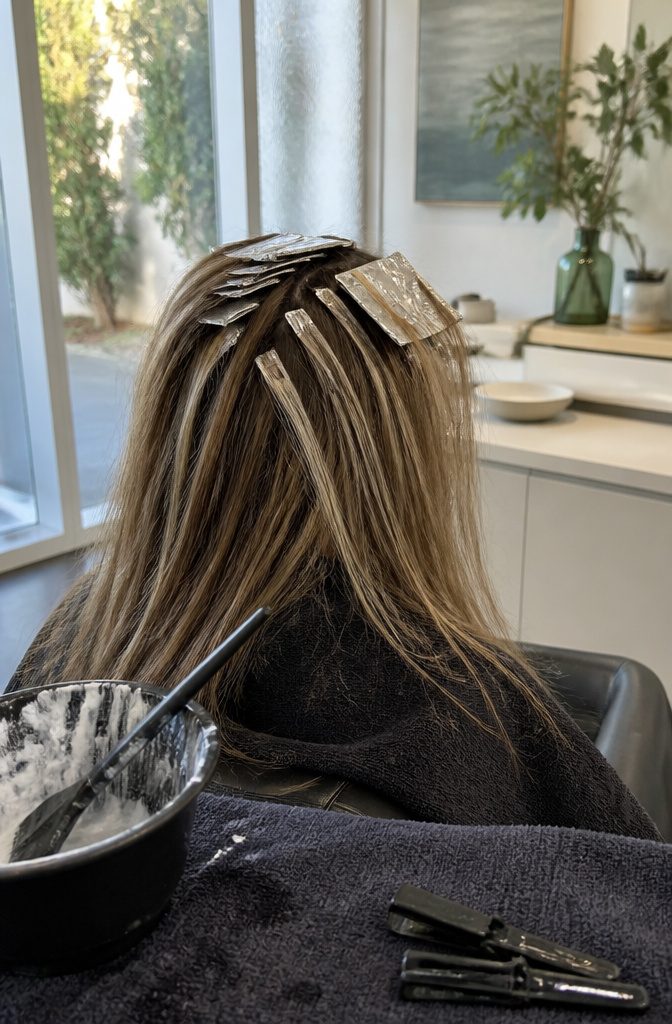 Hair with fine pale highlights and folded foils near the crown