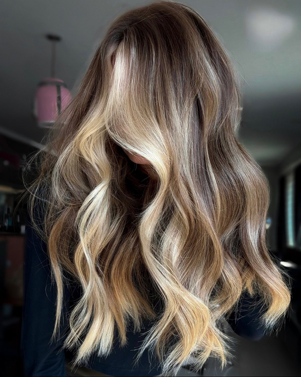 Wavy dark brown hair with strongly contrasting blended blonde balayage highlights