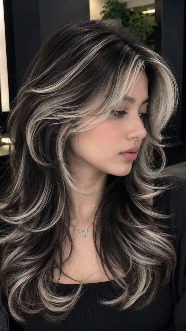 Woman with long dark brunette hair and icy blonde balayage highlights