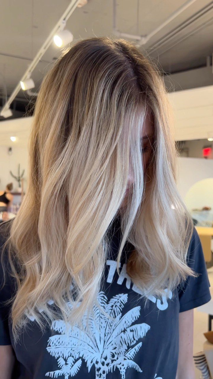 Long brown hair with softly painted blonde face-framing balayage strands